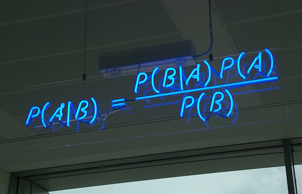 Een neonbord met daarop de P(A\B) formule weergegeven.