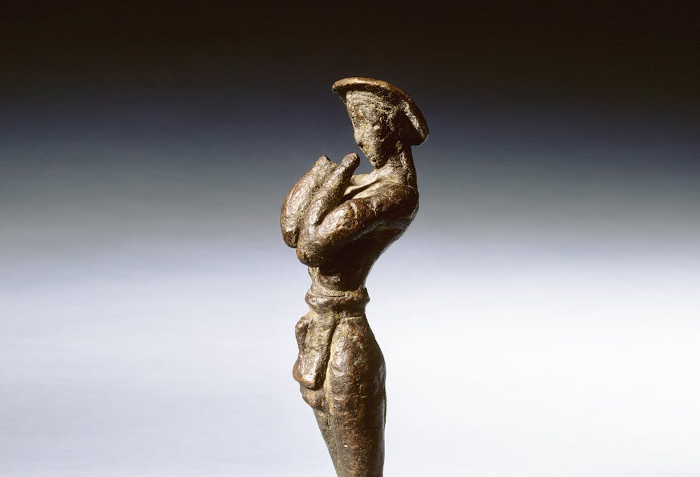 <p>Brons, Grieks, 1580-1475 v.Chr., gevonden op Kreta, h. 14 cm. Dit beeldje is het oudste bronzen voorwerp uit de Grieks-Romeinse collectie van het Rijksmuseum van Oudheden. Het is gemaakt op Kreta, ten tijde van Minoïsche beschaving, die tussen 2000 en 1450 v.Chr. haar grootste bloei kende. Het is gevonden bij de ruïnes van het paleis van Phaistos. De voorgestelde man draagt een lendenschort en een platte hoed. Hij houdt zijn handen voor de borst en gezicht, zodat het lijkt alsof hij aan het bidden is.</p>