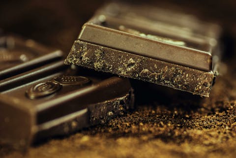 Een leven zonder chocolade is voor veel liefhebbers een ramp. Ook hiervoor zijn onderzoekers bezig met een alternatief in het laboratorium. Gebroken donkere chocoladereep in twee stukken
