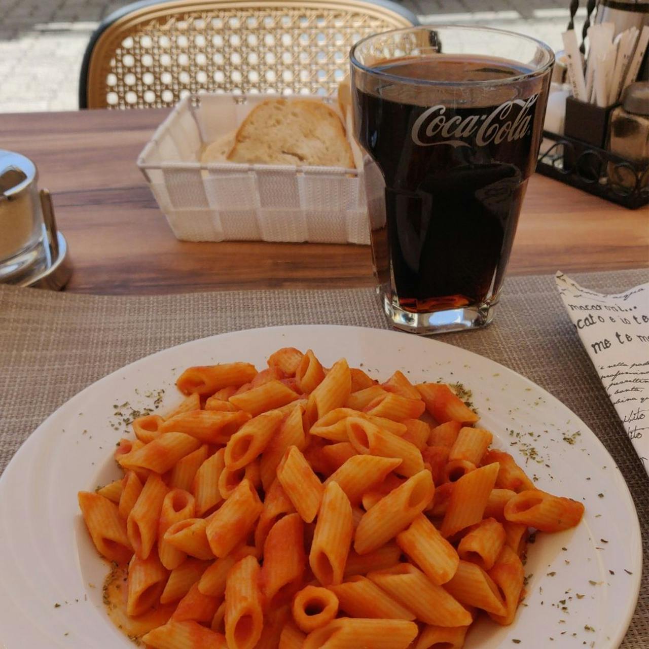 een bord pasta en een glas cola