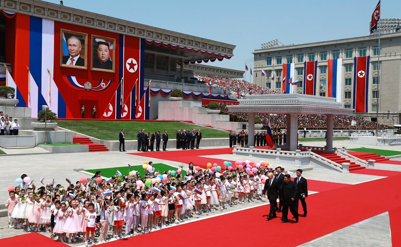 Vladimir Poetin, de president van Rusland, bezoekt Noord-Korea in juni 2024, hij loopt samen met Kim Jong Un over de rode loper en overal zijn vlaggen en mensen te zien