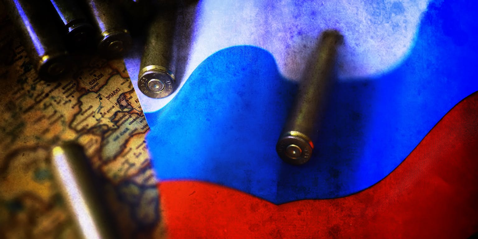 Een russische vlag ligt op een wereldkaart met daarop kogels