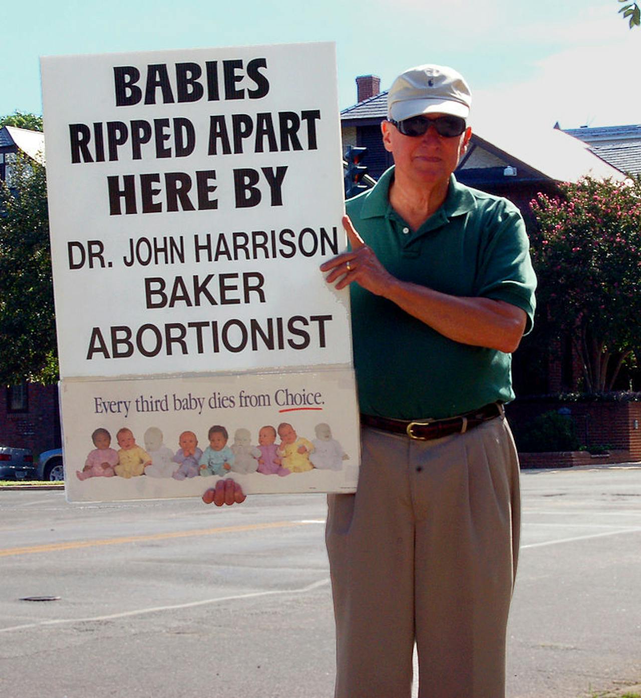 Een man houdt een bord vast waarop staat dat baby's door abortusplegers uit elkaar zijn gescheurd.