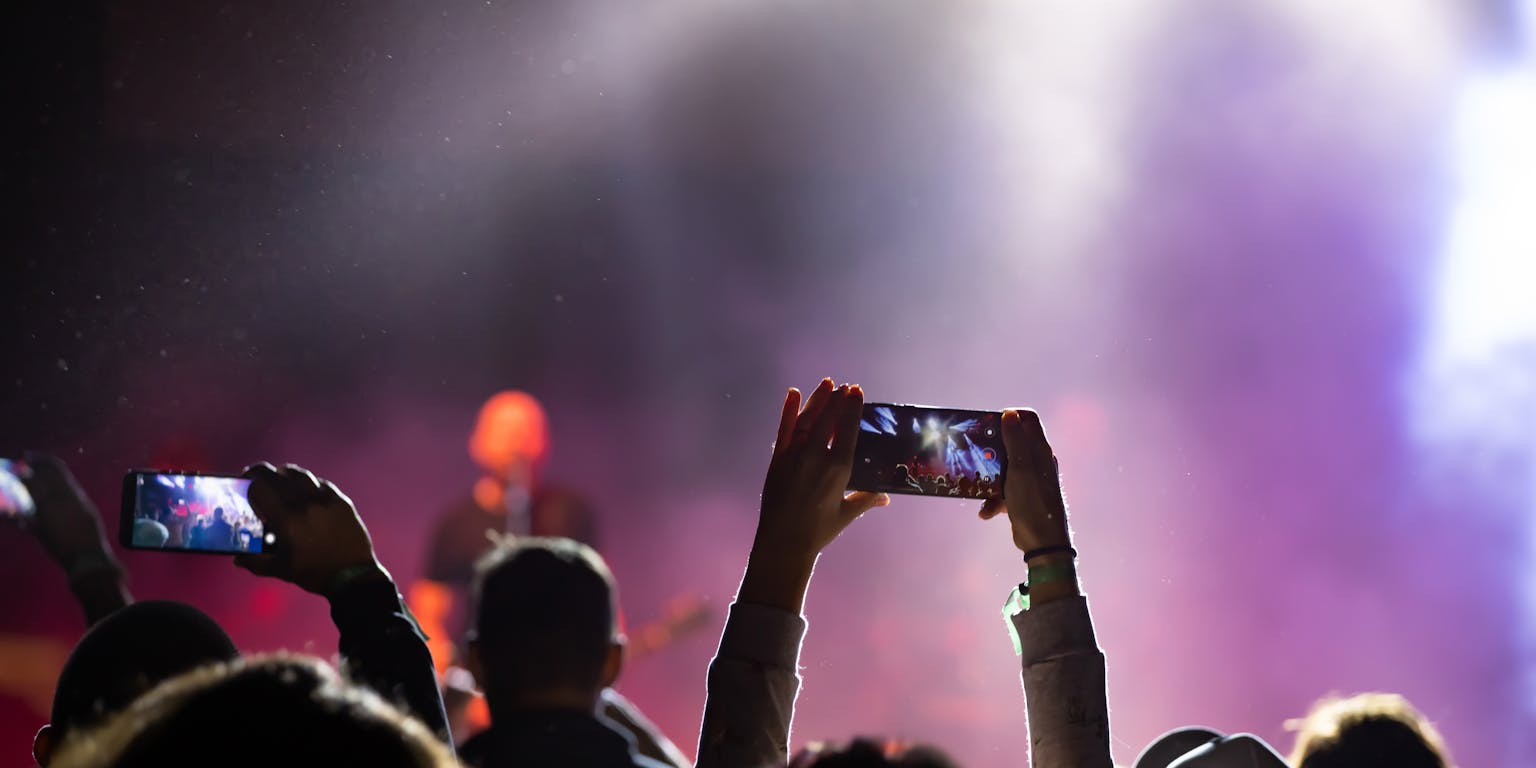 mensen maken foto's tijdens muziekconcert