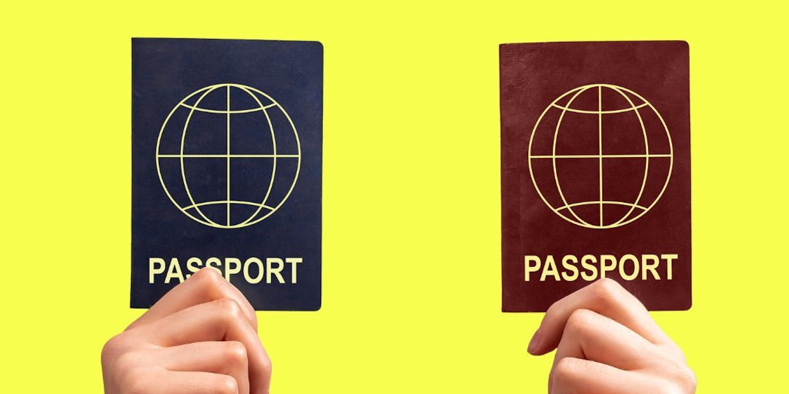 persoon houdt twee verschillende paspoorten vast