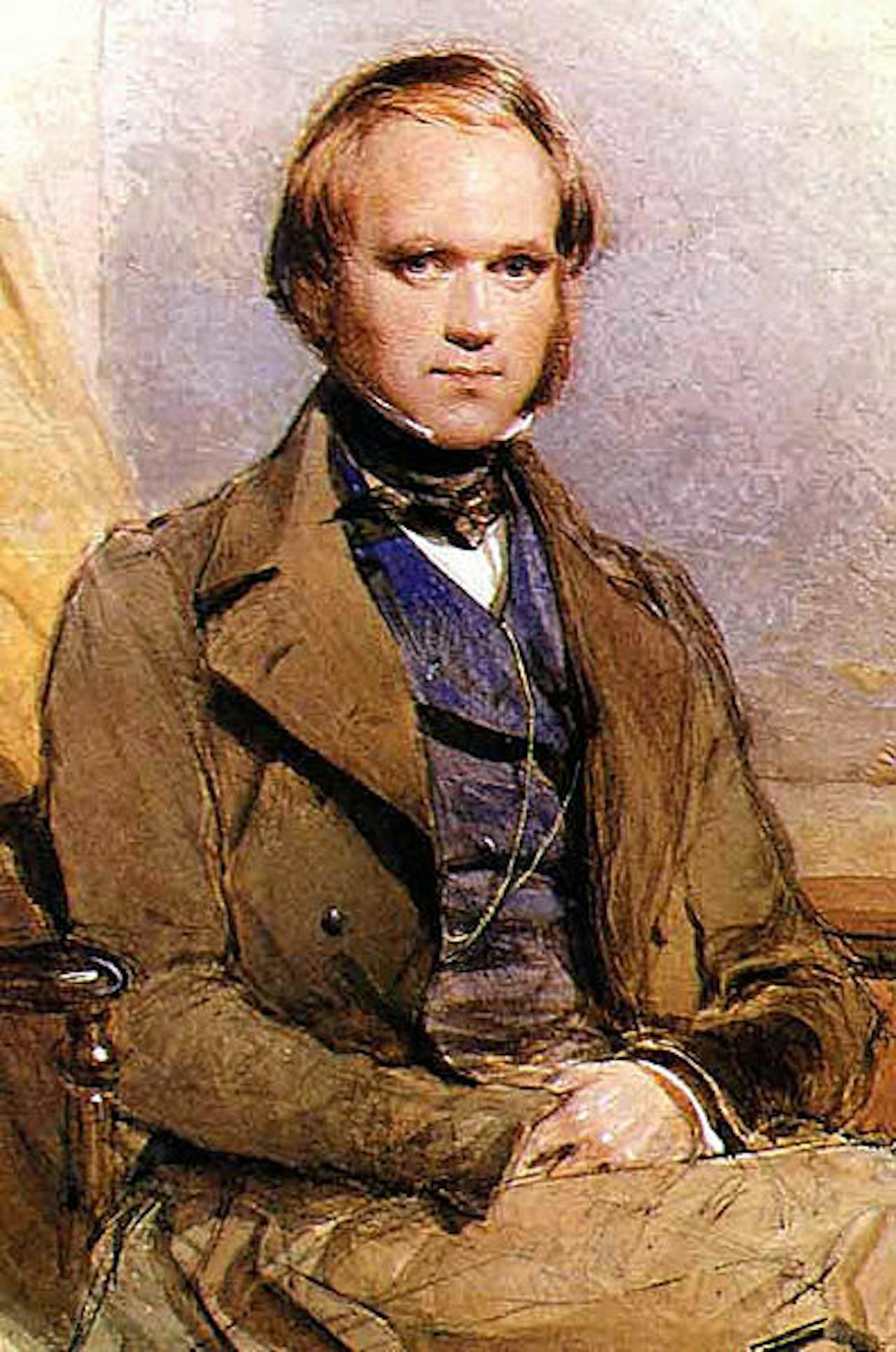 Een portret van Charles Darwin. De man zit op een stoel.