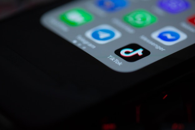 Ingezoomd scherm van een mobiele telefoon waarop het logo van de app TikTok is te zien.