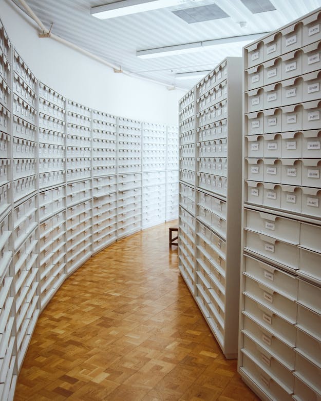 Data hoeft vaak niet oneindig bewaard te worden, en offline opslag is soms ook een goede optie. Witte archiefkasten, met een gebogen pad ertussen.