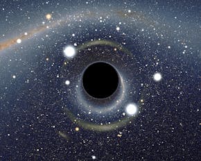 Een afbeelding van een zwart gat omgeven door sterren.
